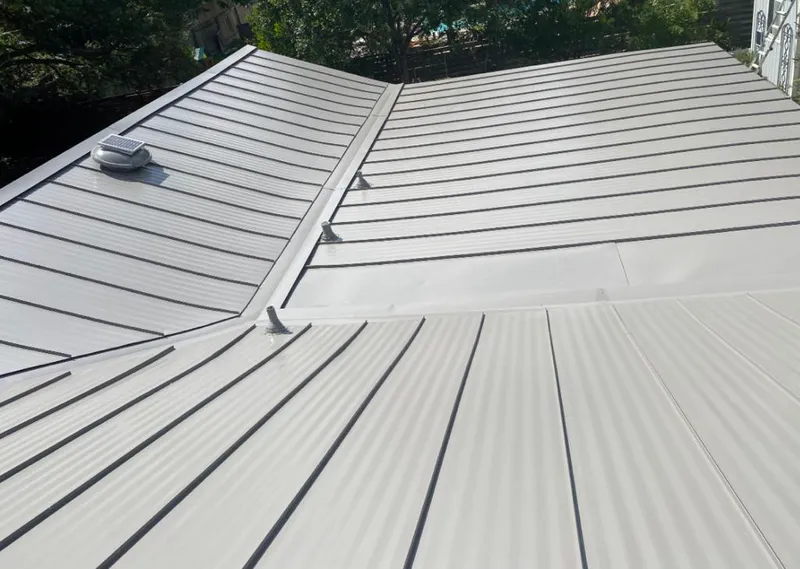 Solar attic fan installed on a metal roof for Roof Ventilation in Sunset