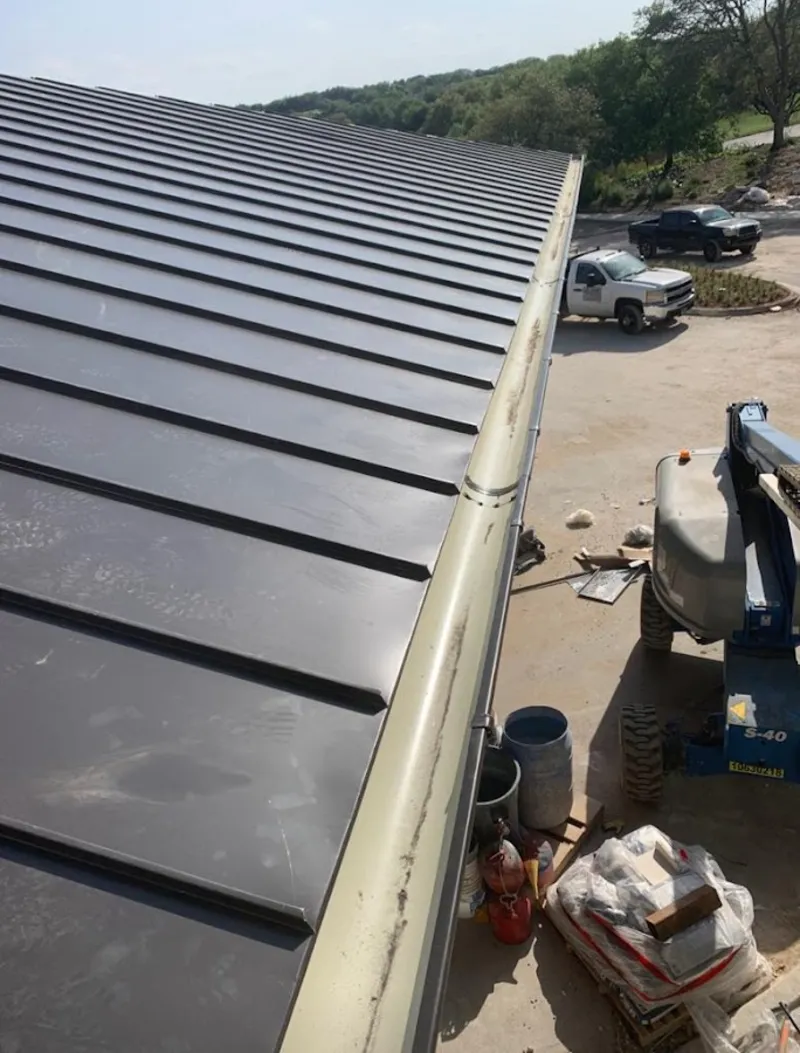 Standing seam panel and gutter detail on a metal roofing jobsite in Sunset